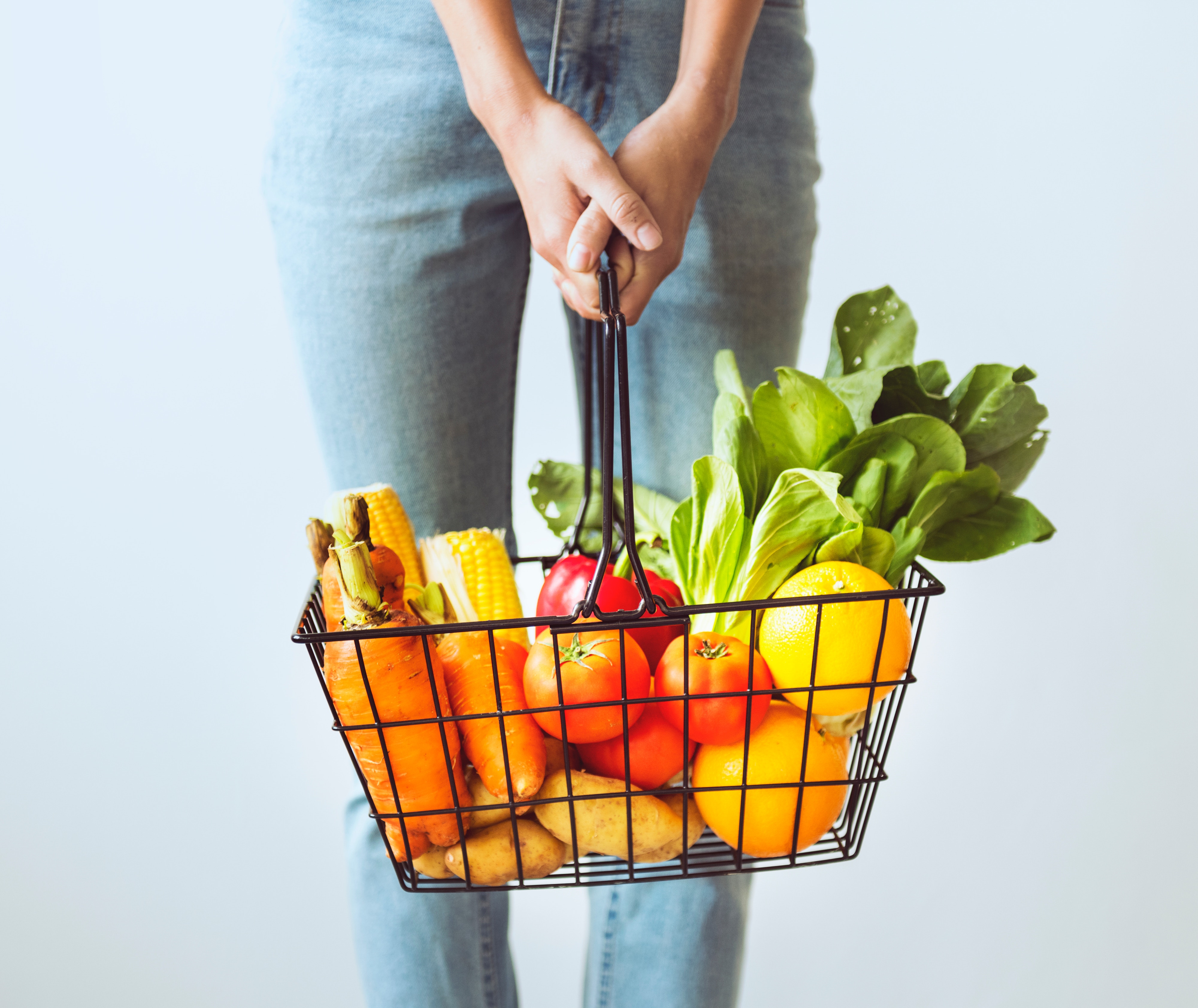 a girl holding a basket of fruit