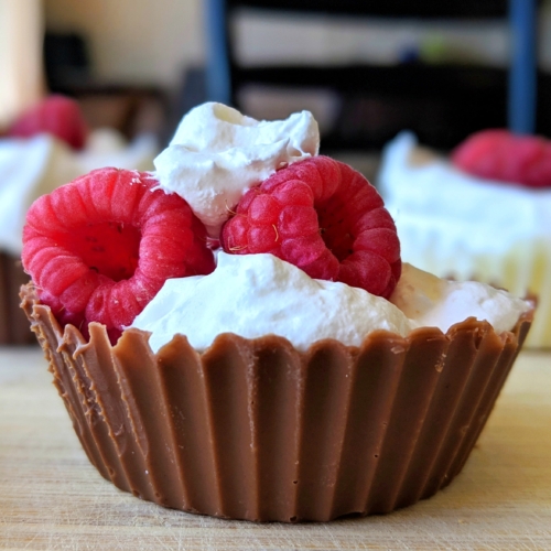 chocolate cups with cream and berries