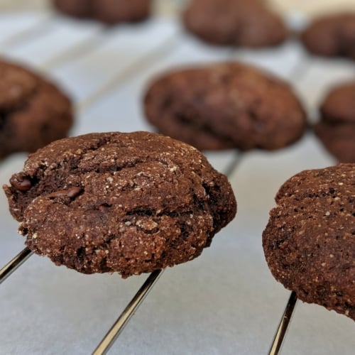 a batch of healthy chocolate cookies on a cooling rack