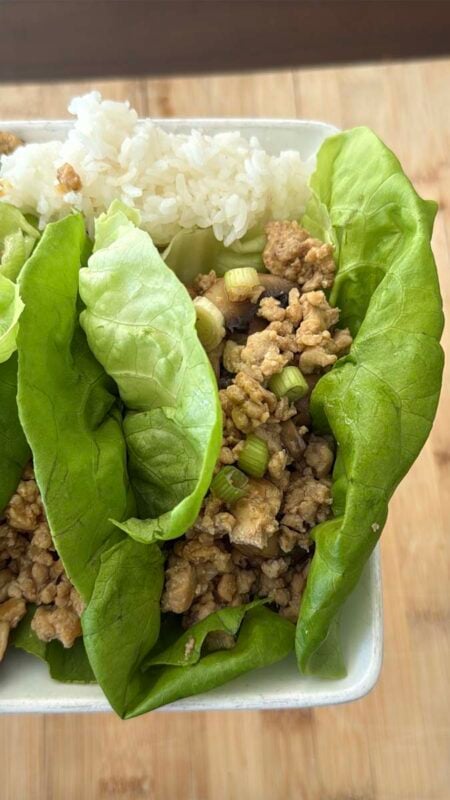 chicken lettuce wraps and white rice in a white bowl
