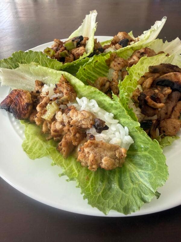 chicken lettuce wraps on a white plate