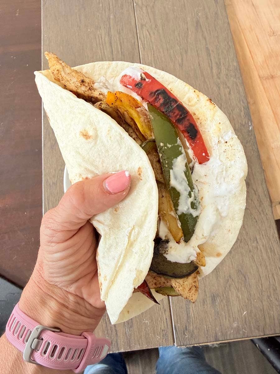 hand holding a High-Protein Chicken Fajita