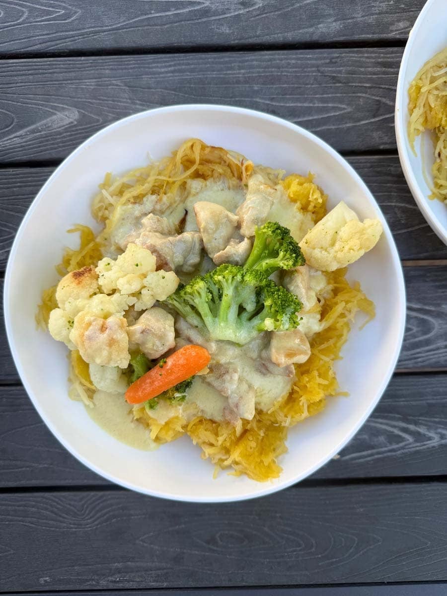 white plate filled with chicken alfredo spaghetti squash