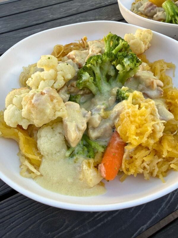 white plate filled with chicken alfredo spaghetti squash
