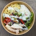 overhead view of a chicken taco bowl in a brown cardboard bowl