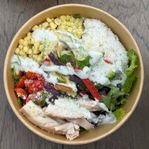 overhead view of a chicken taco bowl in a brown cardboard bowl